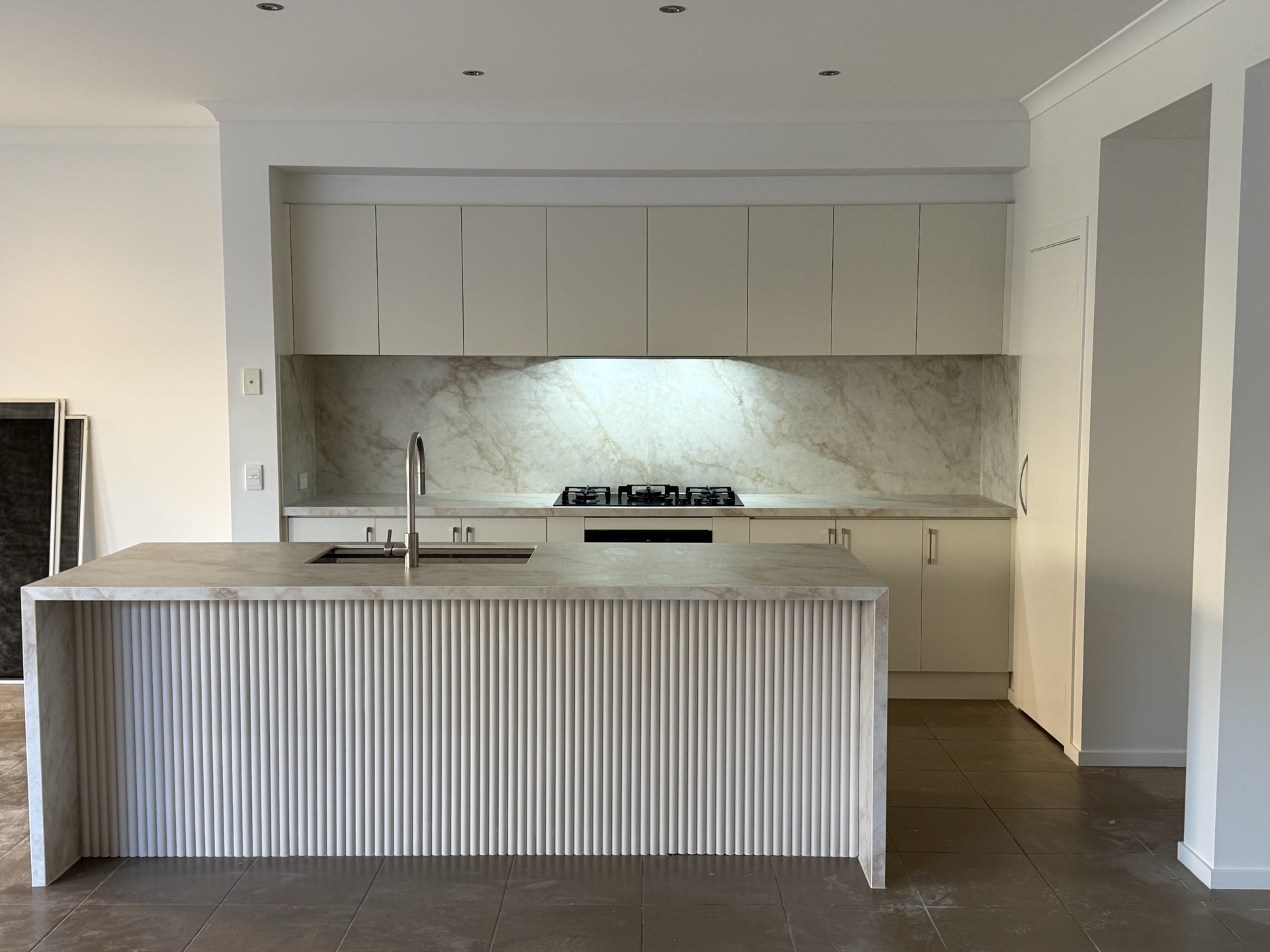 Kitchen after renovation — updated island, brighter finishes and reworked layout