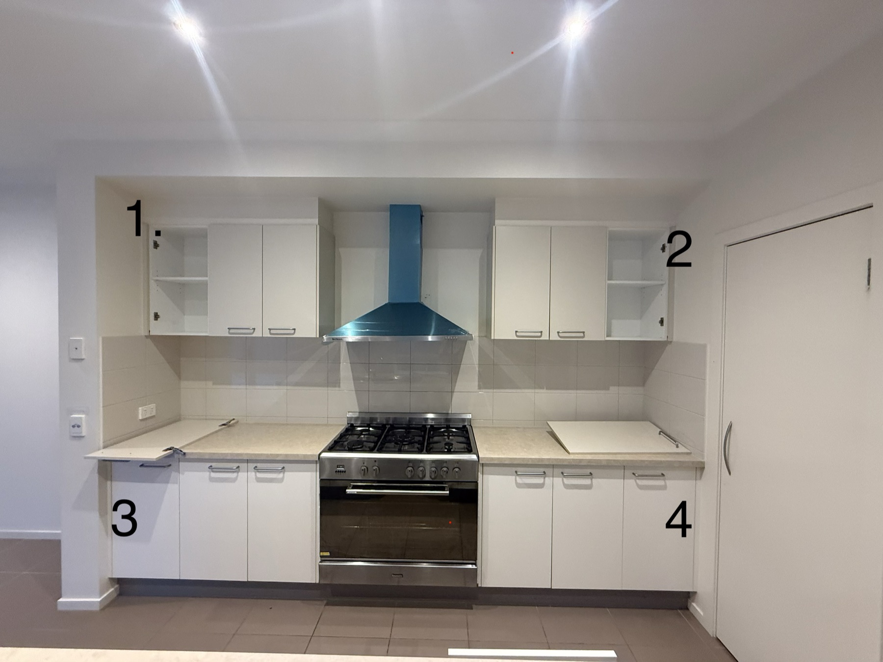 Kitchen before renovation — original cabinetry and dated layout